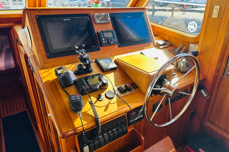 Slide: The Image of Helm of 2006 Sabre 42 Fly Bridge with navigation equipment and wooden finish. - 2