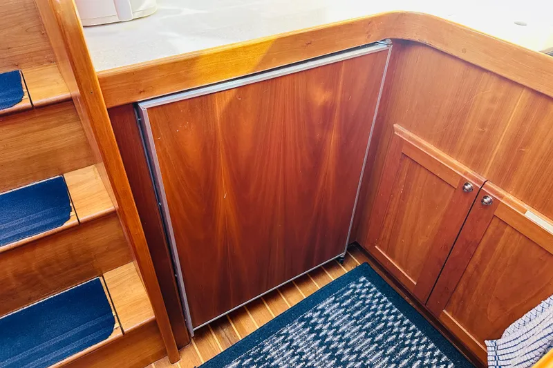 Slide: The Image of Wooden interior of 2006 Sabre 42 Fly Bridge yacht, featuring stairs and cabinetry. - 26
