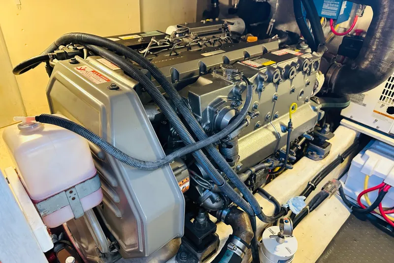 Slide: The Image of Engine room of 2006 Sabre 42 Fly Bridge yacht, showcasing detailed machinery components. - 33