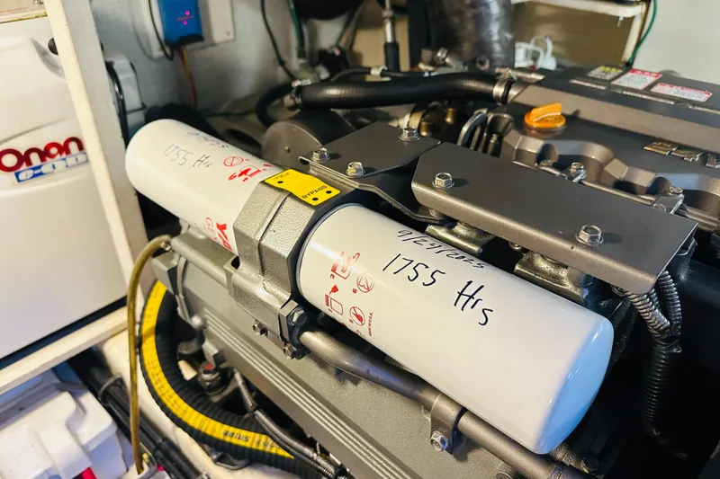 Slide: The Image of Engine room of 2006 Sabre 42 Fly Bridge with Onan generator and filter details. - 35