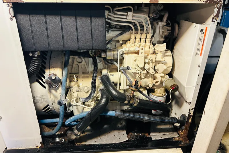 Slide: The Image of Engine compartment of a 2006 Sabre 42 Fly Bridge, showcasing mechanical components and hoses. - 37