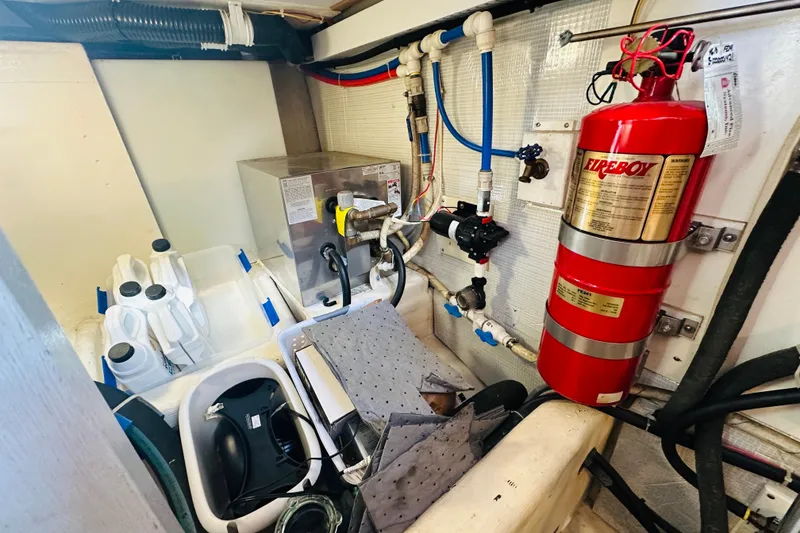 Slide: The Image of Engine room of 2006 Sabre 42 Fly Bridge with fire extinguisher and equipment. - 40