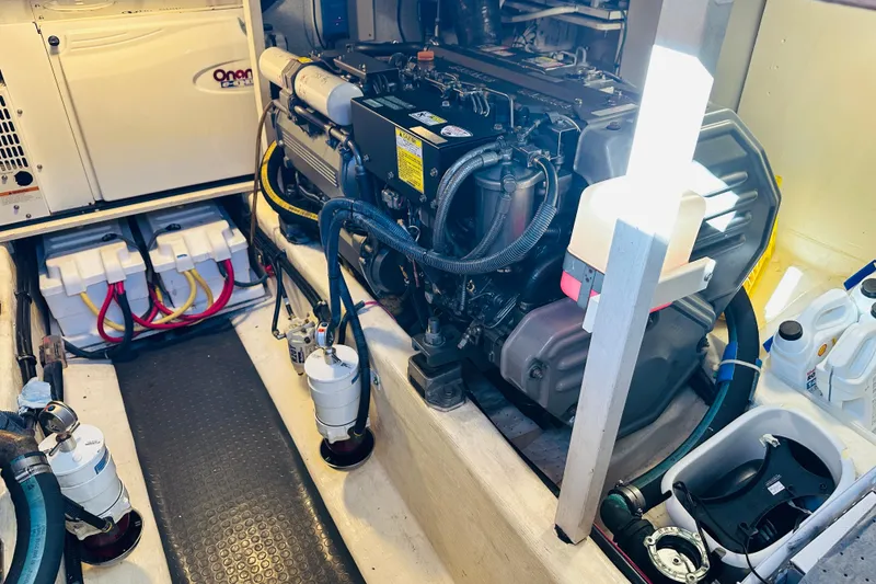 Slide: The Image of Engine room of 2006 Sabre 42 Fly Bridge with Onan generator and dual batteries. - 45