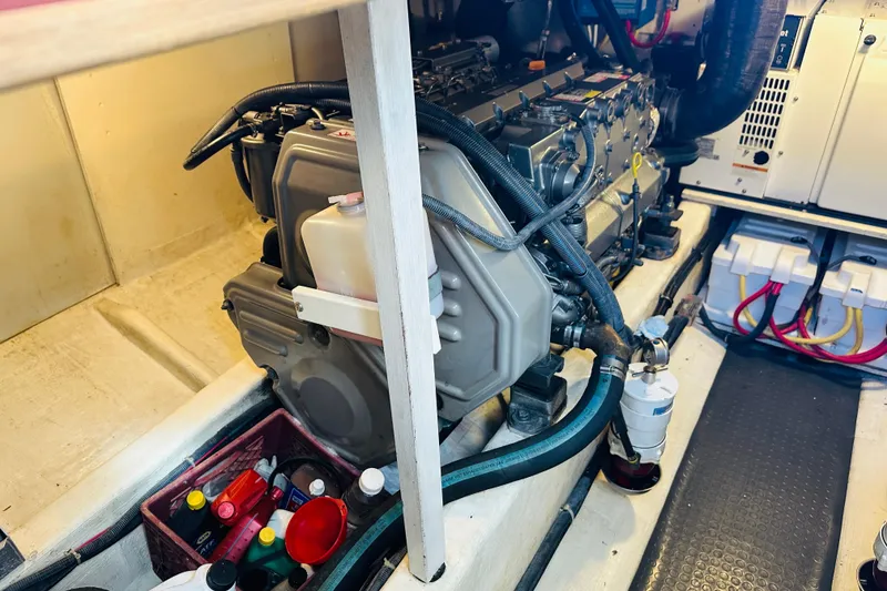 Slide: The Image of Engine room of 2006 Sabre 42 Fly Bridge with visible components and maintenance supplies. - 46