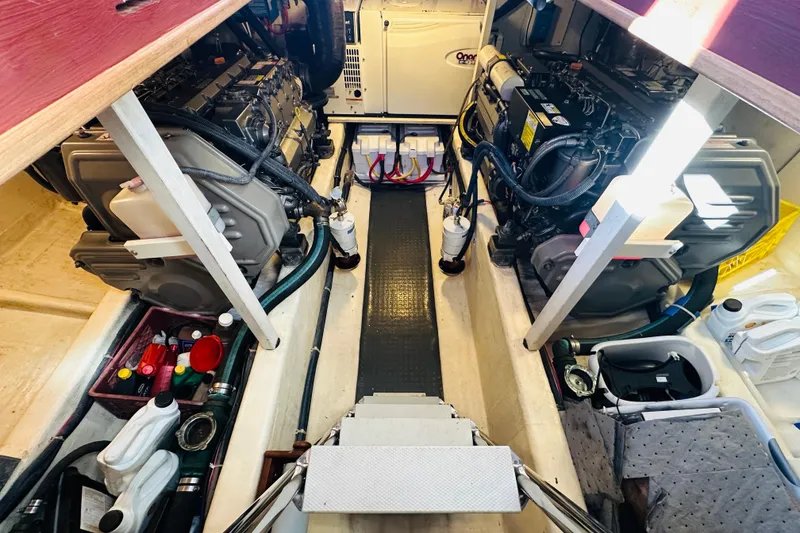 Slide: The Image of Engine room of 2006 Sabre 42 Fly Bridge with dual engines and maintenance supplies. - 47
