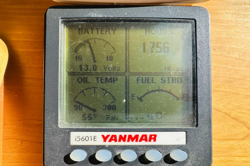 Slide: The Image of Yanmar engine display showing battery, oil temperature, hours, and fuel status on 2006 Sabre 42 Fly Bridge. - 49