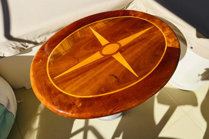 Slide: The Image of Wooden table with compass design on 2006 Sabre 42 Fly Bridge yacht. - 57