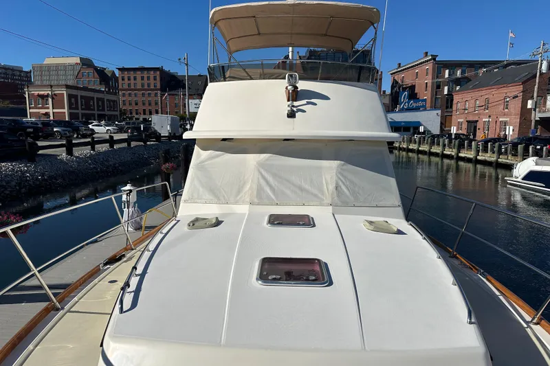 Slide: The Image of 2006 Sabre 42 Fly Bridge yacht docked in urban marina setting. - 63