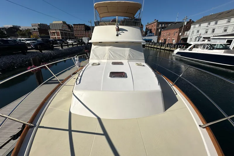 Slide: The Image of 2006 Sabre 42 Fly Bridge yacht docked at a marina, showcasing its sleek design. - 64