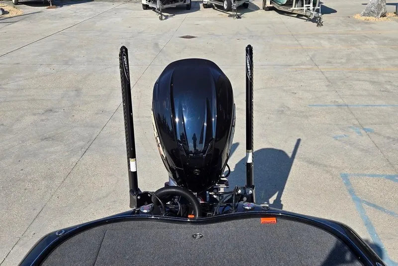 Slide: The Image of 2024 Blazer 650 Pro Tour boat engine and deck in a parking area. - 10