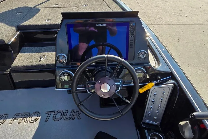 Slide: The Image of 2024 Blazer 650 Pro Tour boat dashboard with steering wheel and navigation display. - 13