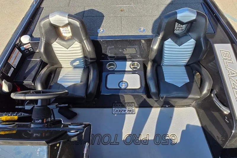 Slide: The Image of 2024 Blazer 650 Pro Tour boat interior with dual seats and steering wheel. - 14