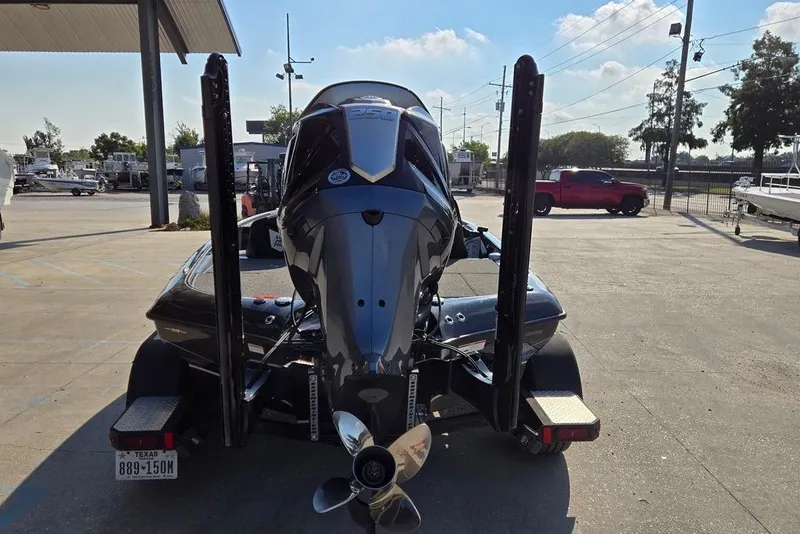 Slide: The Image of 2024 Blazer 650 Pro Tour boat with powerful outboard motor, parked outdoors. - 4