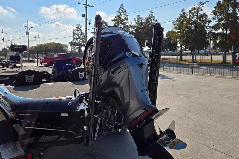 Slide: The Image of 2024 Blazer 650 Pro Tour boat with powerful outboard motor in a sunny outdoor setting. - 5