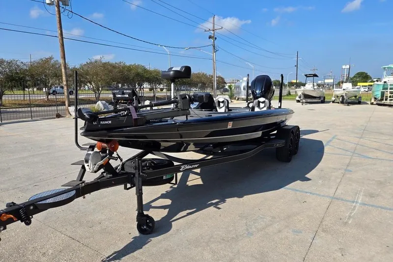Slide: The Image of 2024 Blazer 650 Pro Tour boat on trailer in outdoor lot. - 7
