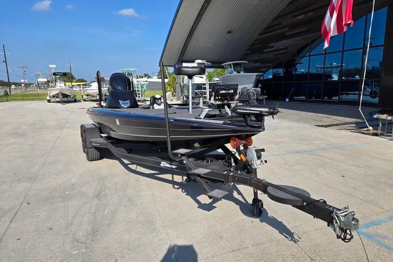 Slide: The Image of 2024 Blazer 650 Pro Tour boat on trailer, parked outdoors under clear blue sky. - 9