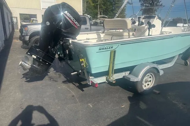 Slide: The Image of 2024 Boston Whaler 170 Montauk boat on trailer with Mercury outboard motor. - 2