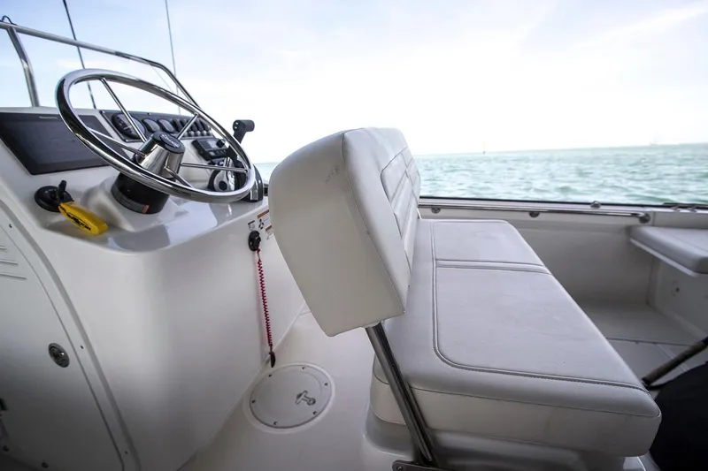 Slide: The Image of Manufacturer Provided Image: 2024 Boston Whaler 170 Montauk boat interior with steering wheel and seating. - 24