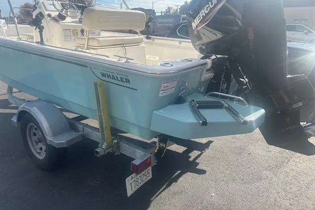 Slide: The Image of 2024 Boston Whaler 170 Montauk boat on trailer with Mercury outboard motor. - 5