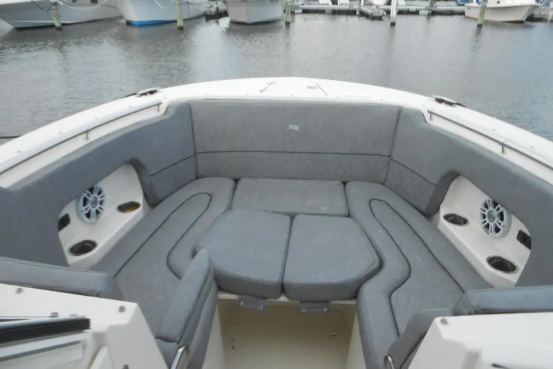Slide: The Image of 2022 Stingray 269 DC boat interior with gray cushioned seating and cup holders. - 5