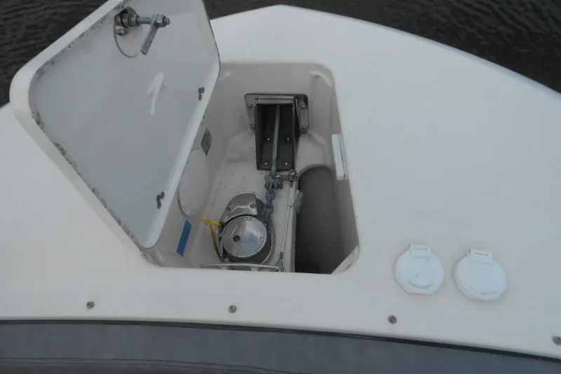 Slide: The Image of Anchor compartment of 2022 Stingray 269 DC boat, open hatch with visible chain and mechanism. - 6