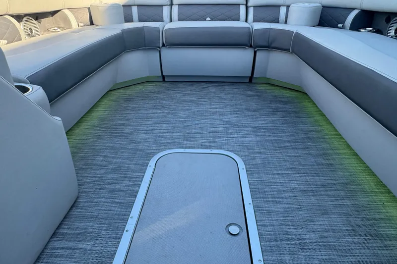 Slide: The Image of 2021 Bennington L 25 Swingback boat interior with gray seating and flooring. - 10