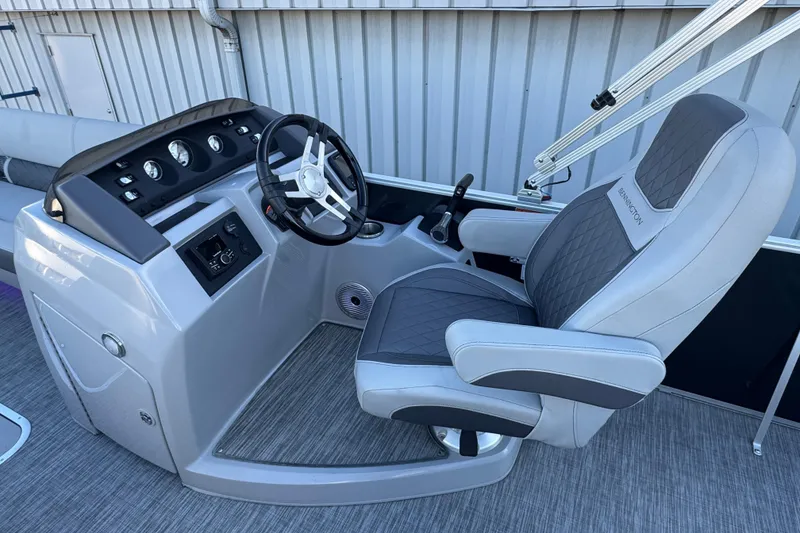 Slide: The Image of 2021 Bennington L 25 Swingback boat helm with steering wheel and captain's chair. - 14