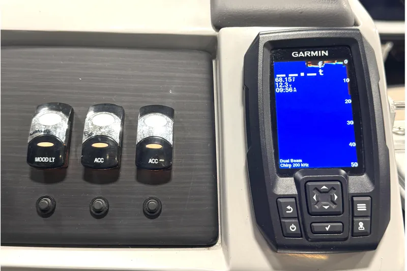 Slide: The Image of Control panel of a 2021 Bennington L 25 Swingback with Garmin display and switches. - 19