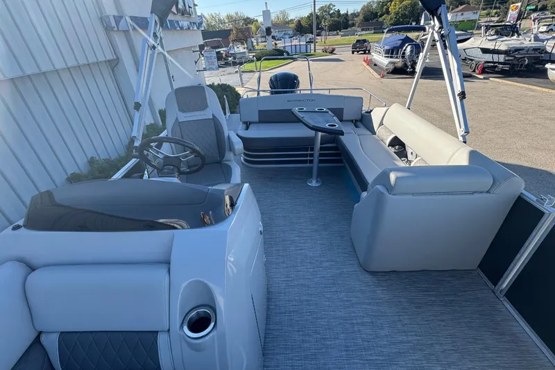 Slide: The Image of 2021 Bennington L 25 Swingback pontoon boat interior with seating and steering console. - 22