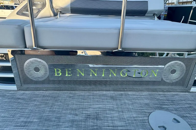 Slide: The Image of 2021 Bennington L 25 Swingback pontoon boat with stylish seating and logo detail. - 28