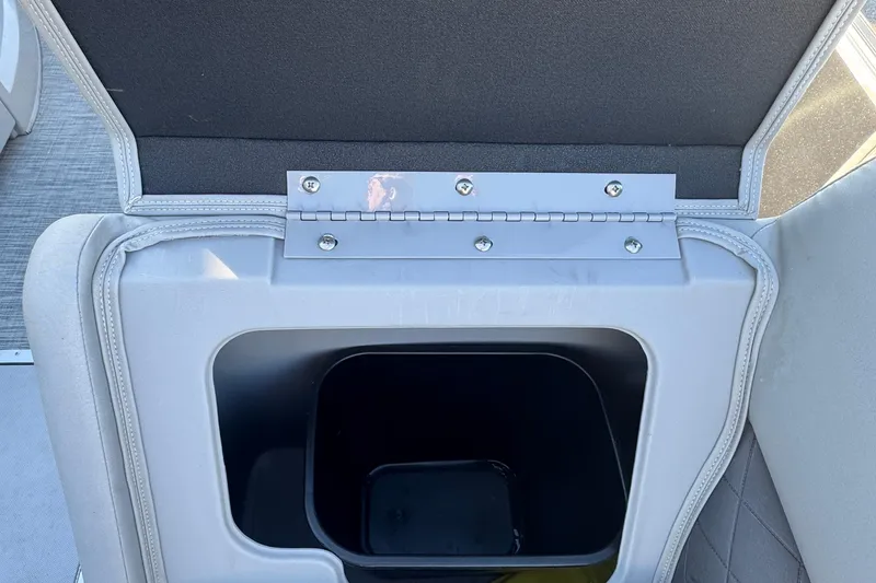 Slide: The Image of Open storage compartment in 2021 Bennington L 25 Swingback boat, featuring a hinged lid. - 31