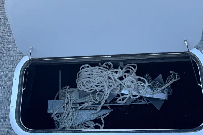 Slide: The Image of Open storage compartment on 2021 Bennington L 25 Swingback with anchor and rope. - 32