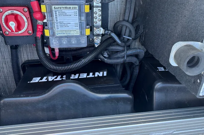 Slide: The Image of Electrical components and battery setup in a 2021 Bennington L 25 Swingback boat. - 34