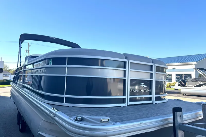 Slide: The Image of 2021 Bennington L 25 Swingback pontoon boat in a marina setting. - 4