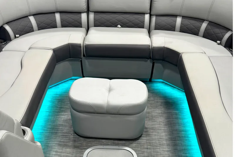 Slide: The Image of Luxurious seating area of 2021 Bennington L 25 Swingback with ambient blue lighting. - 5
