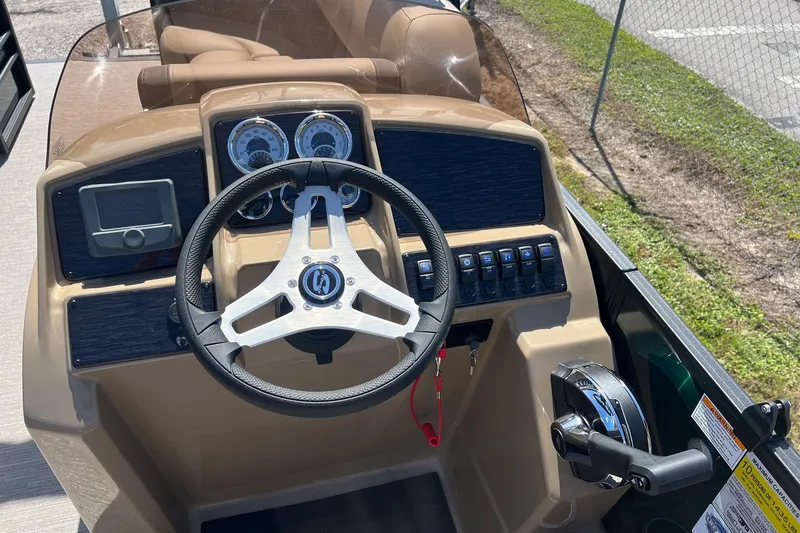 Slide: The Image of 2026 Sylvan Mirage 822 CLZ boat dashboard with steering wheel and control panel. - 12