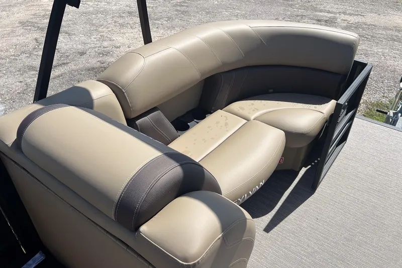 Slide: The Image of 2026 Sylvan Mirage 822 CLZ boat with beige leather seating, outdoor setting. - 17