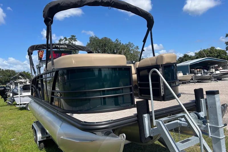 Slide: The Image of 2026 Sylvan Mirage 822 CLZ pontoon boat on trailer, sunny day, outdoor display. - 6
