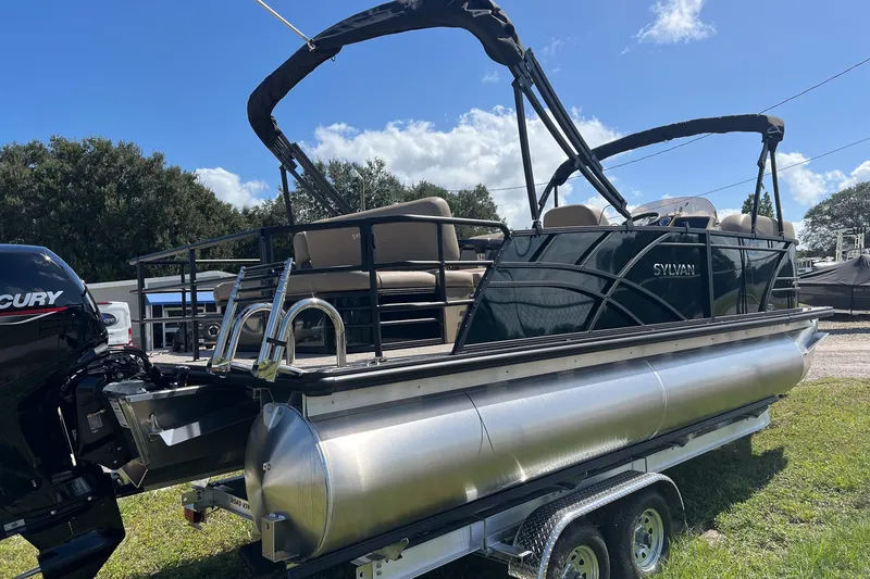 Slide: The Image of 2026 Sylvan Mirage 822 CLZ pontoon boat on trailer, sunny day, outdoor setting. - 8