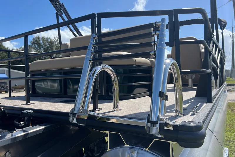 Slide: The Image of 2026 Sylvan Mirage 822 CLZ pontoon boat with stainless steel ladder and seating area. - 9