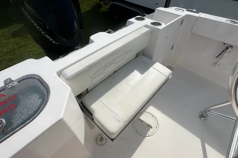 Slide: The Image of 2023 Aquasport 2200 Center Console boat interior with white seating and cup holders. - 10