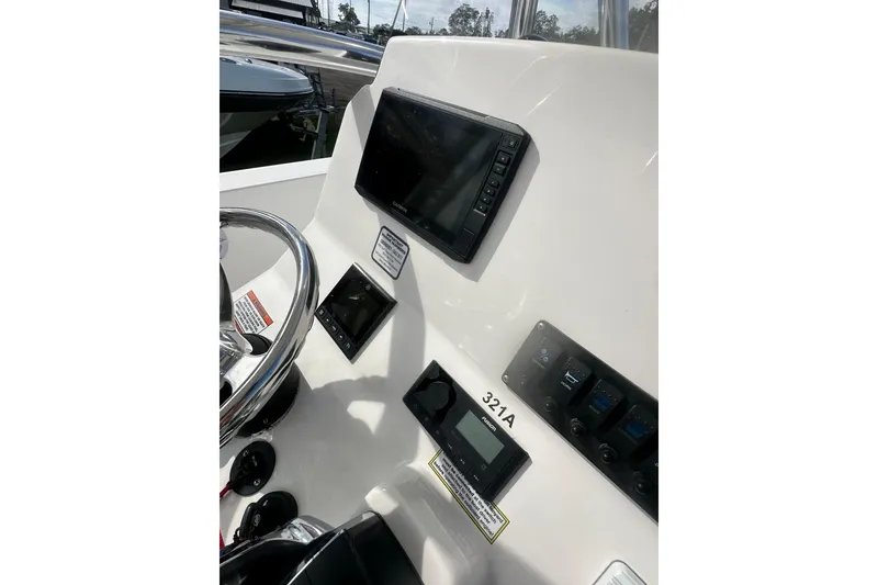 Slide: The Image of 2023 Aquasport 2200 Center Console dashboard with navigation and control panels. - 12