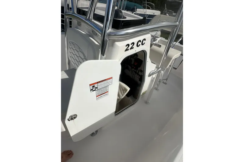 Slide: The Image of 2023 Aquasport 2200 Center Console boat interior with open storage compartment. - 17