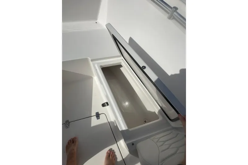 Slide: The Image of Open storage compartment on 2023 Aquasport 2200 Center Console boat. - 19