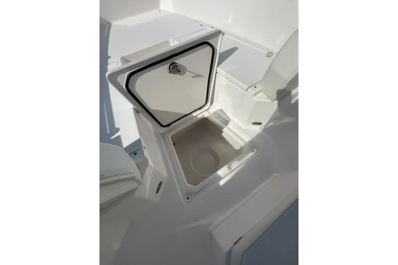Slide: The Image of 2023 Aquasport 2200 Center Console boat storage compartment, open and empty. - 20