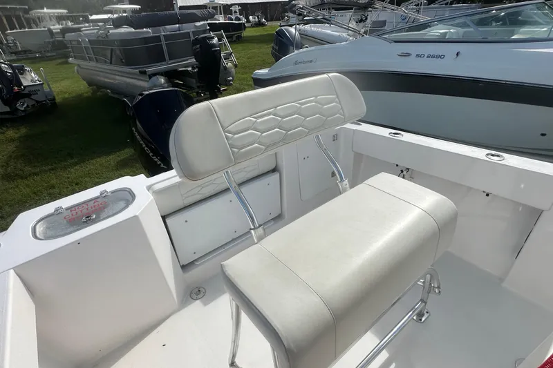 Slide: The Image of 2023 Aquasport 2200 Center Console boat interior with white seating and sleek design. - 21