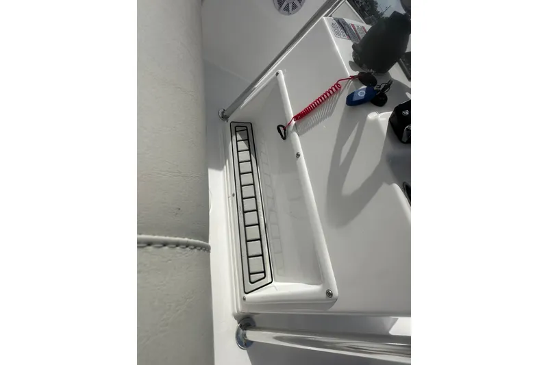 Slide: The Image of 2023 Aquasport 2200 Center Console dashboard with safety lanyard and controls. - 24