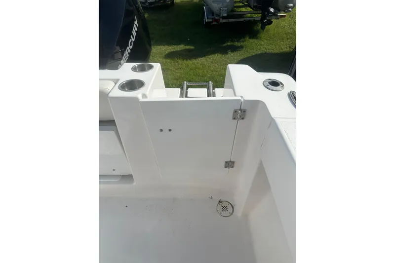 Slide: The Image of 2023 Aquasport 2200 Center Console boat interior with cup holders and ladder. - 27