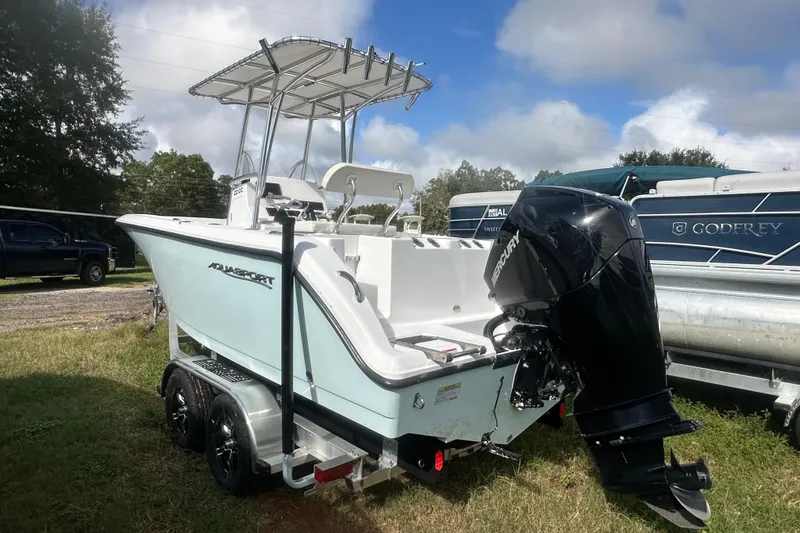 Slide: The Image of 2023 Aquasport 2200 Center Console boat with Mercury outboard motor on trailer. - 3