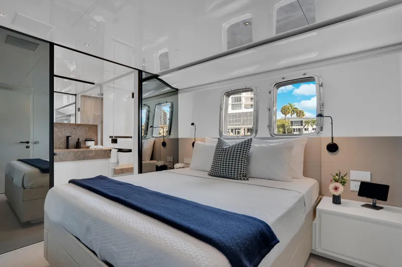 Slide: The Image of Luxurious 2023 Sanlorenzo SL96A yacht bedroom with modern design and scenic window view. - 16